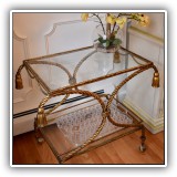 F11. Gold trimmed bar cart with tassles. Dimensions: 30.5W x 16.5"D x 25.5"T - $225