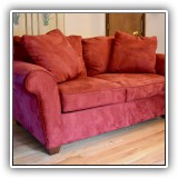 F13. Bauhaus red ultrasuede loveseat. Dimensions: 65"W x 37.5"D x 33.5"T - $250