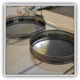 S18. Pair of round silverplate trays with black bottoms. 10"w and 12"w - $24 for the pair
