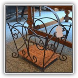 D83. Metal and rattan magazine rack. - $24