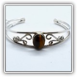 J24. Silver scroll bracelet with tiger's eye. - $24