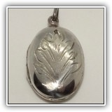 J13. Sterling silver locket. About 1" - $14